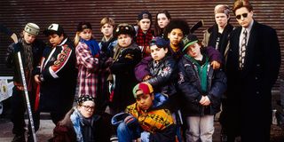 The Mighty Ducks team and coach lineup in front of a brick wall
