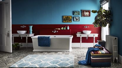 How to decorate a bathroom with a blue painted wall white bath and sink basin and luxury vinyl tile flooring