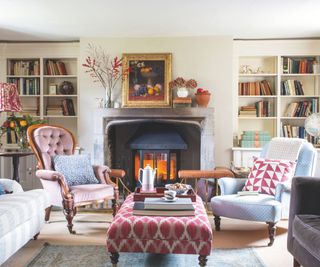 Traditional living room with a fireplace, fireplace fender, armchairs and ottoman