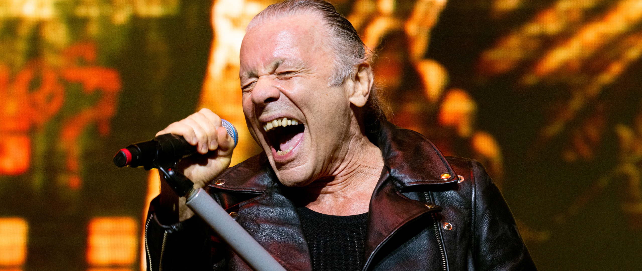 Bruce Dickinson singing onstage with Iron Maiden in 2025