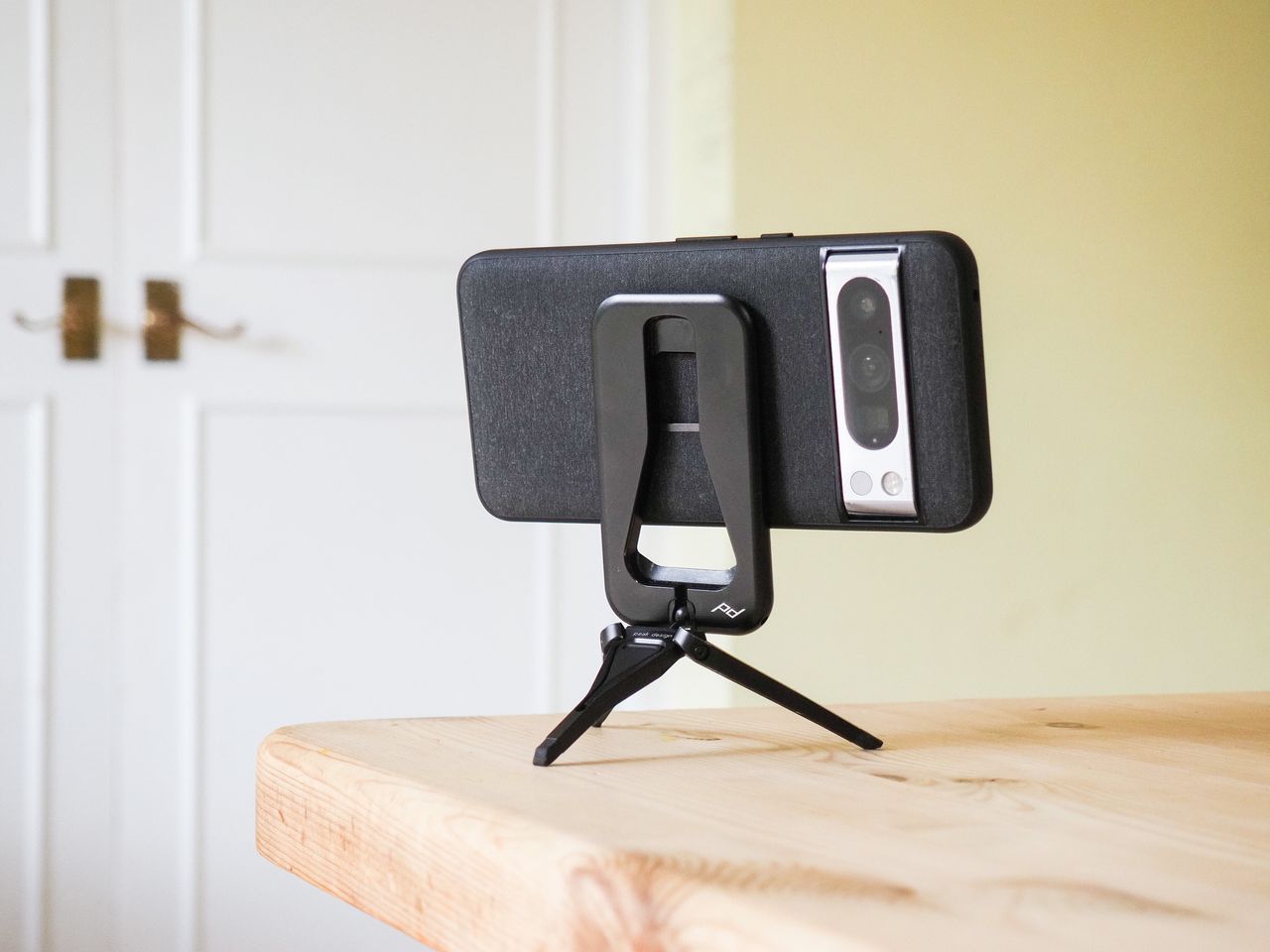 Peak Design Mobile Tripod folded away in use on a table, with a Pixel phone attached