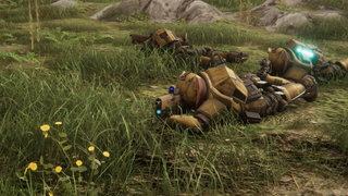 Soldiers lie in wait in the grass.