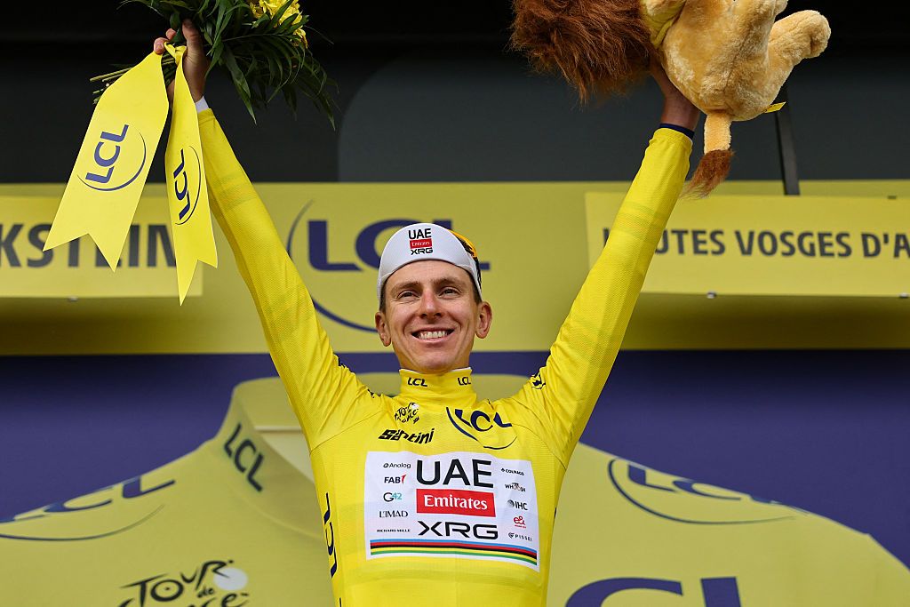 UAE Team Emirates - XRG's Slovenian rider Tadej Pogacar celebrates on the podium with the overall leader's yellow jersey after the 14th stage of the 113th edition of the Tour de France cycling race, 155,3 km between Mulhouse and Le Markstein in the Vosges mountains, on July 18, 2026. (Photo by Anne-Christine POUJOULAT / AFP)