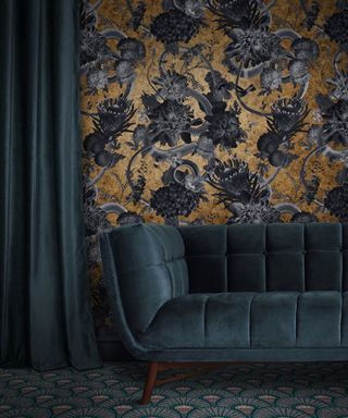 Dark gray and gold floral wallpaper, dark blue velvet sofa, matching curtain