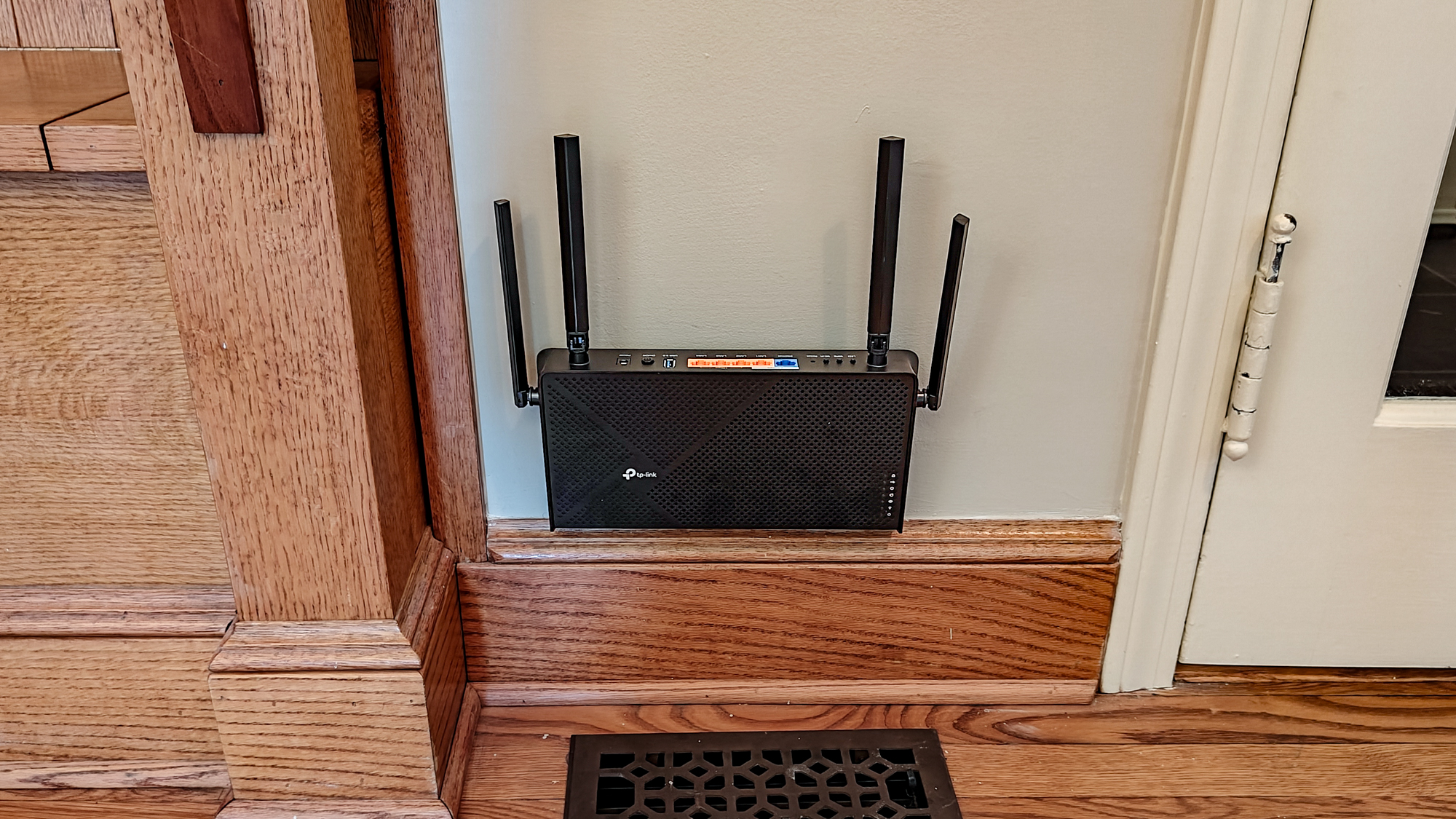 TP-Link Archer BE3600 attached to a wall