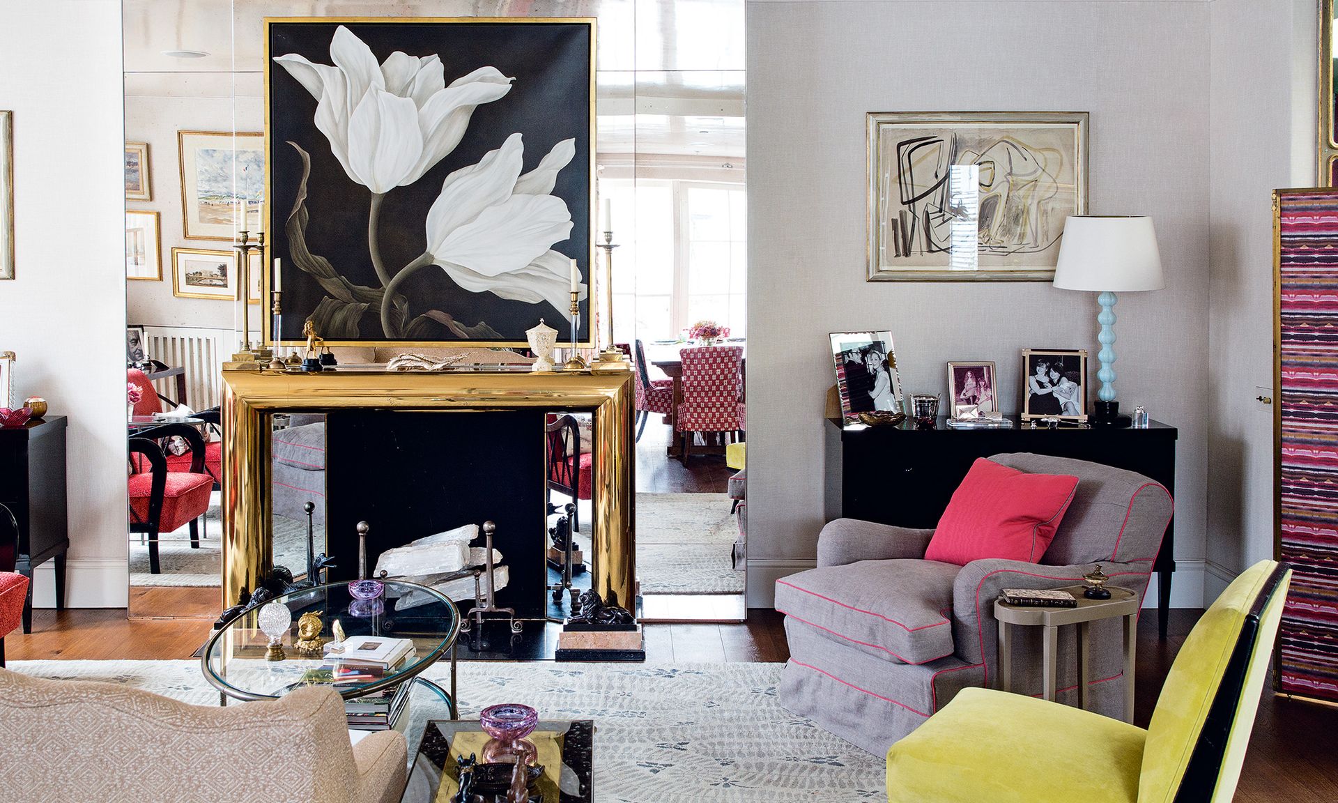 Living room with central fireplace and sofa and armchairs