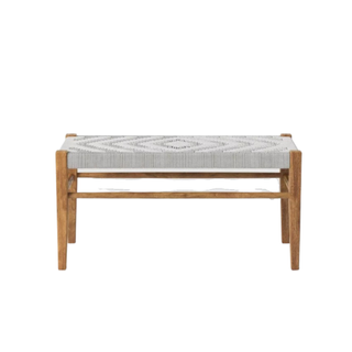 A wooden bench with a woven seat