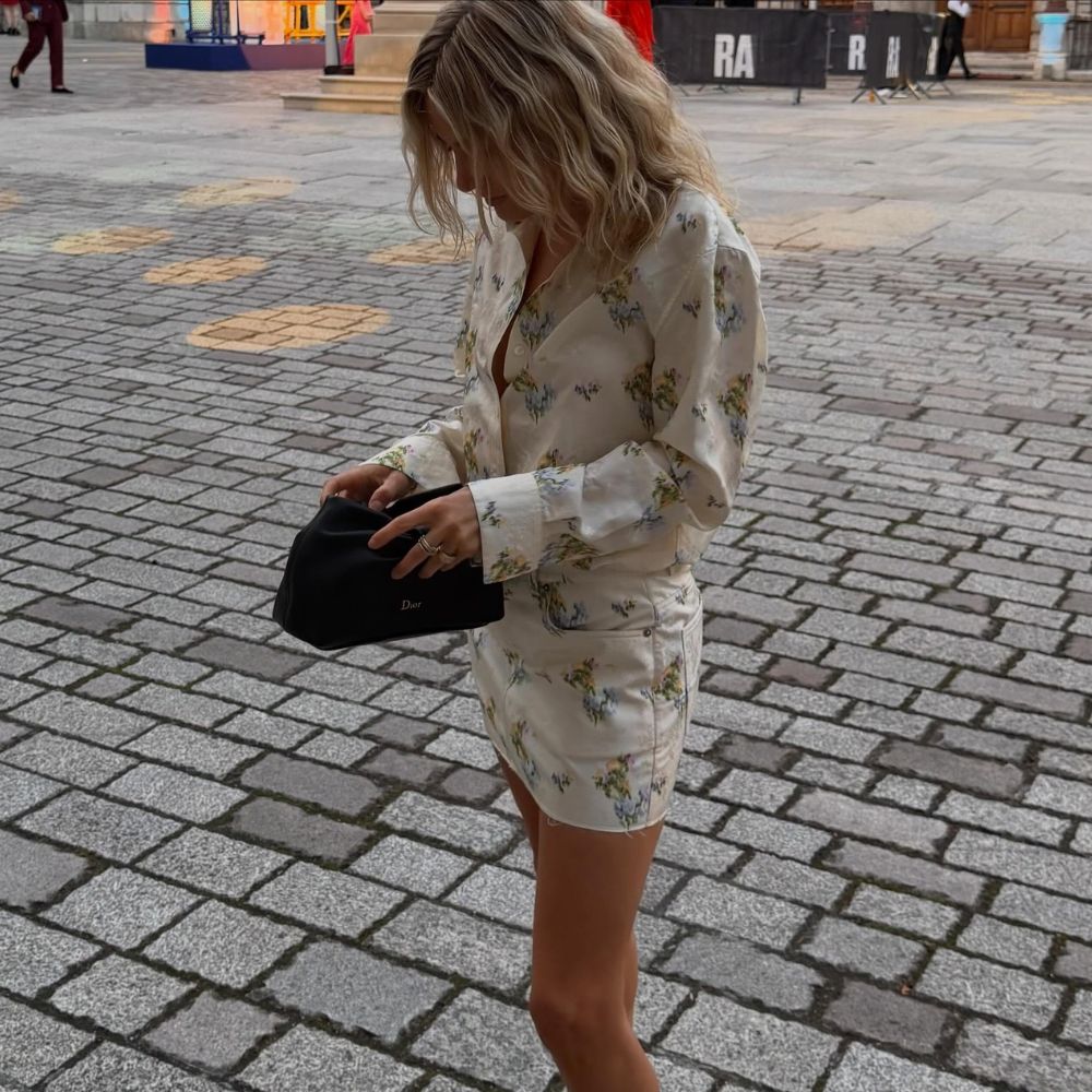 Influencer @lucywilliams02 wears a floral minidress with sculptural wedge thong heels.