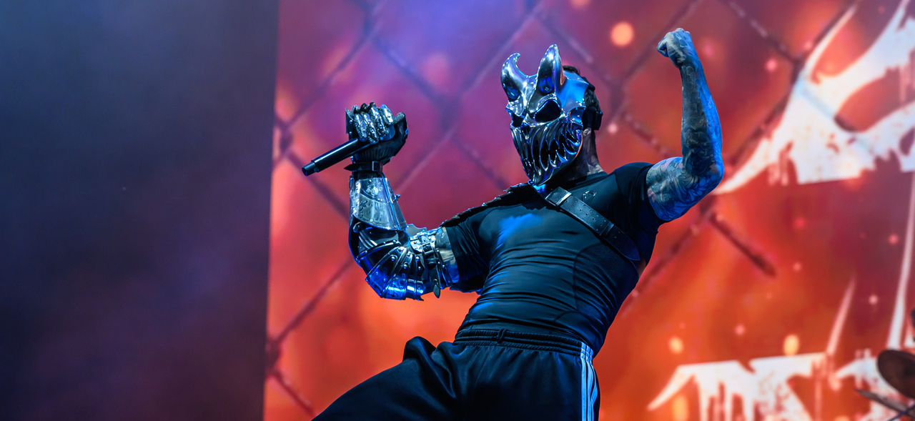 Alex Terrible in his mask posing on stage