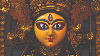 Surajit Sen interview; an Indian art of a female face with stylised features, rendered in gold, sculpted in Zbrush