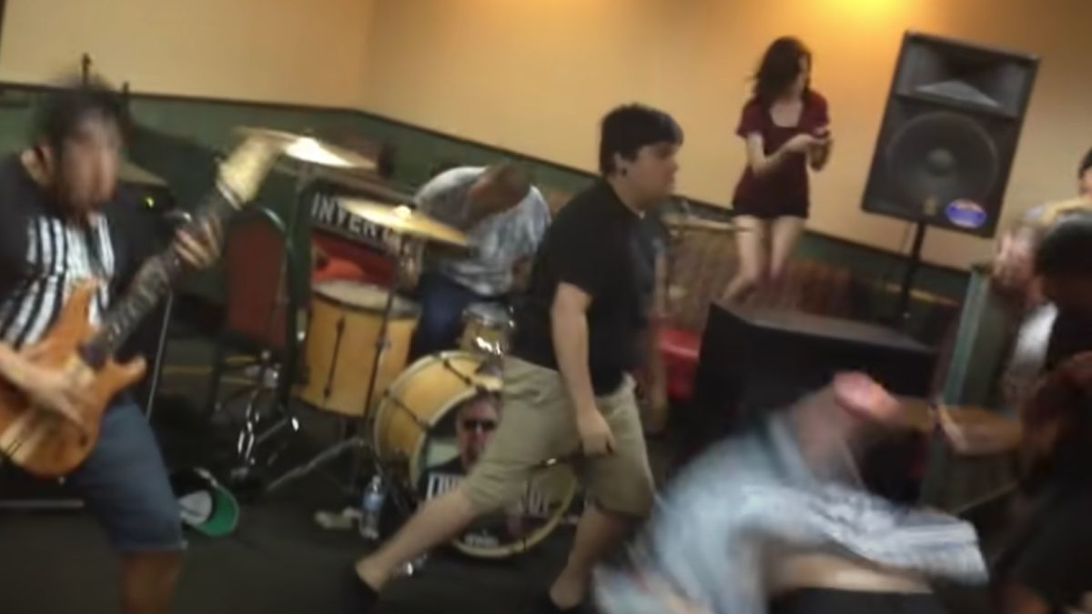 A metal band performing in a Denny&#039;s restaurant, in front of a raging moshpit