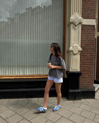 London Summer Shoe Trends: @francescasaffari  wears blue trainers with white shorts and a grey tee