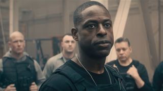 Sterling K. Brown looking serious while addressing other agents in Paradise. 