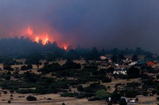 RYE, COLORADO - JULY 3: The Aspen Acres fire burns behind homes on July 3, 2026 in Rye, Colorado. Over 73,000 acres have burned in the Aspen Acres fire, making it the eighth biggest fire in Colorado history. (Photo by Michael Ciaglo/Getty Images)