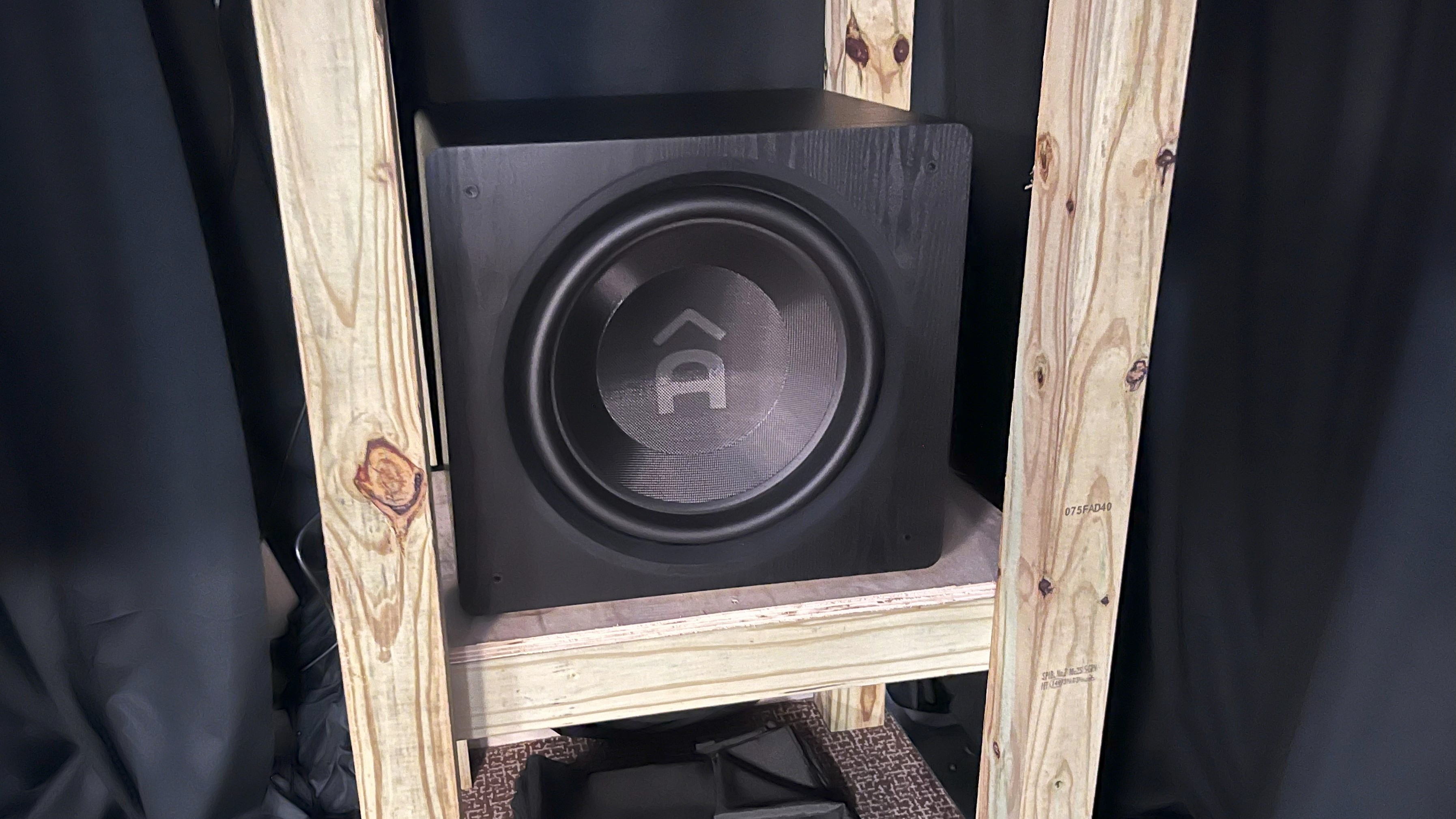 Ascendo The16 Sub Active Sealed subwoofer on makeshift wooden stand