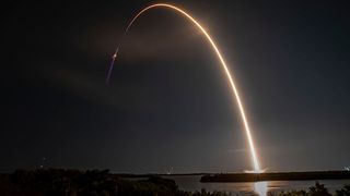 SpaceX's Falcon 9 rocket seen blasting off toward the International Space Station with a Cargo Dragon capsule atop.