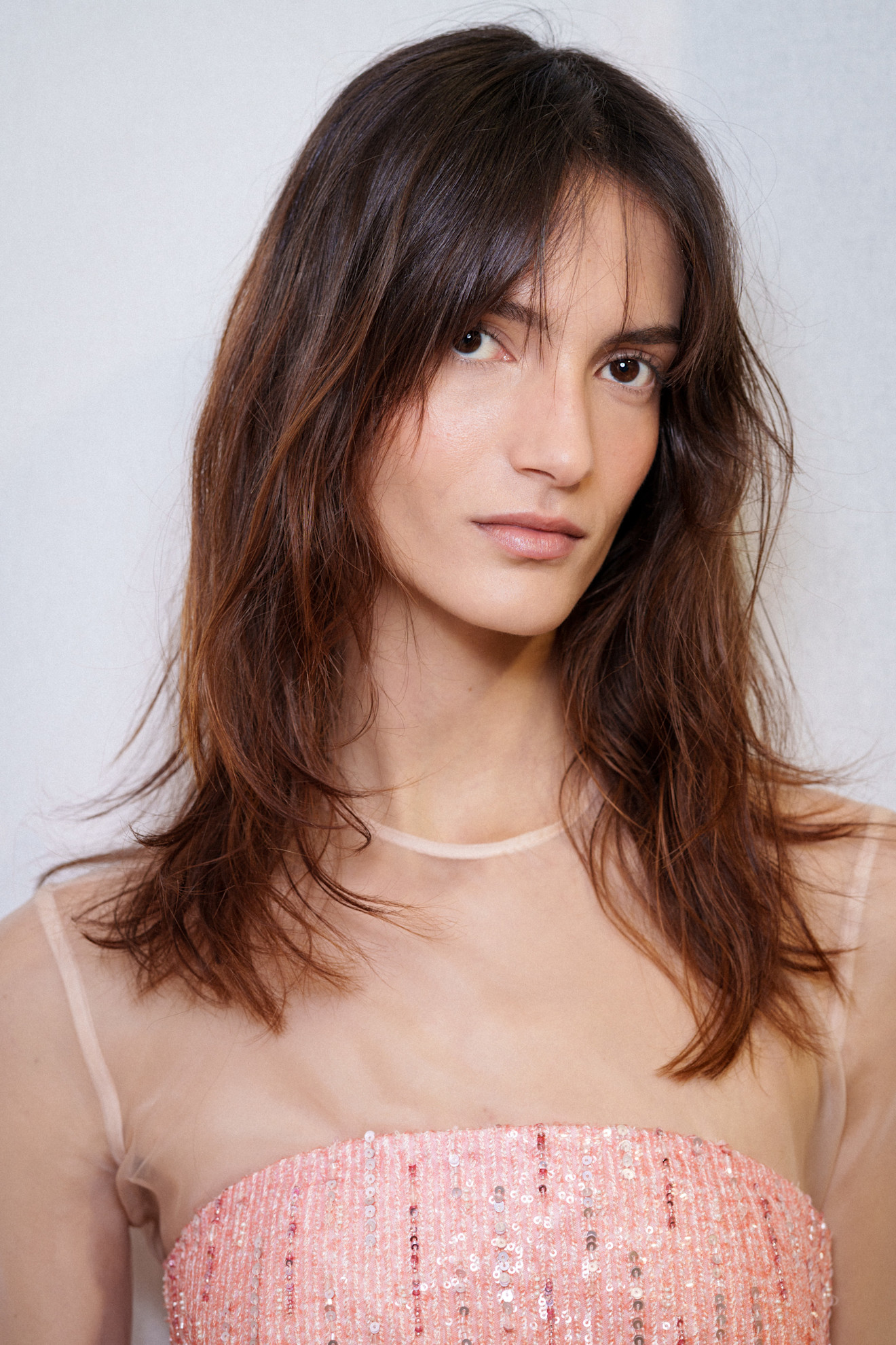 A model wearing their hair in a shag haircut.