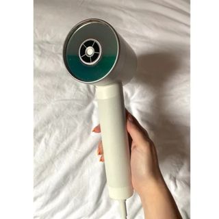 Original image showing handheld view of the Zuvi Halo Hair Dryer