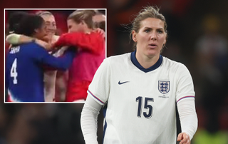 Millie Bright pointing at the blue of Naomi Girma's shirt