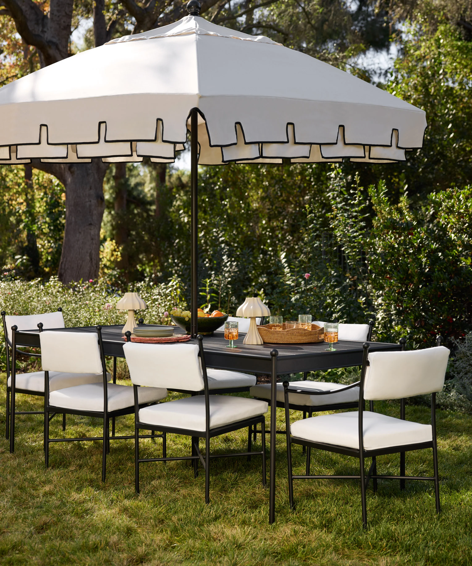 a dining scene with a table, several chairs, and an umbrella