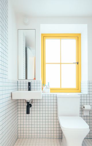 colourful bathroom with yellow window frame