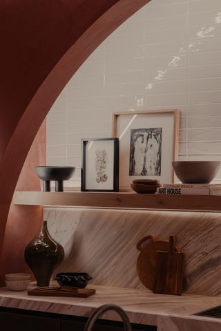 A kitchen with terracotta walls
