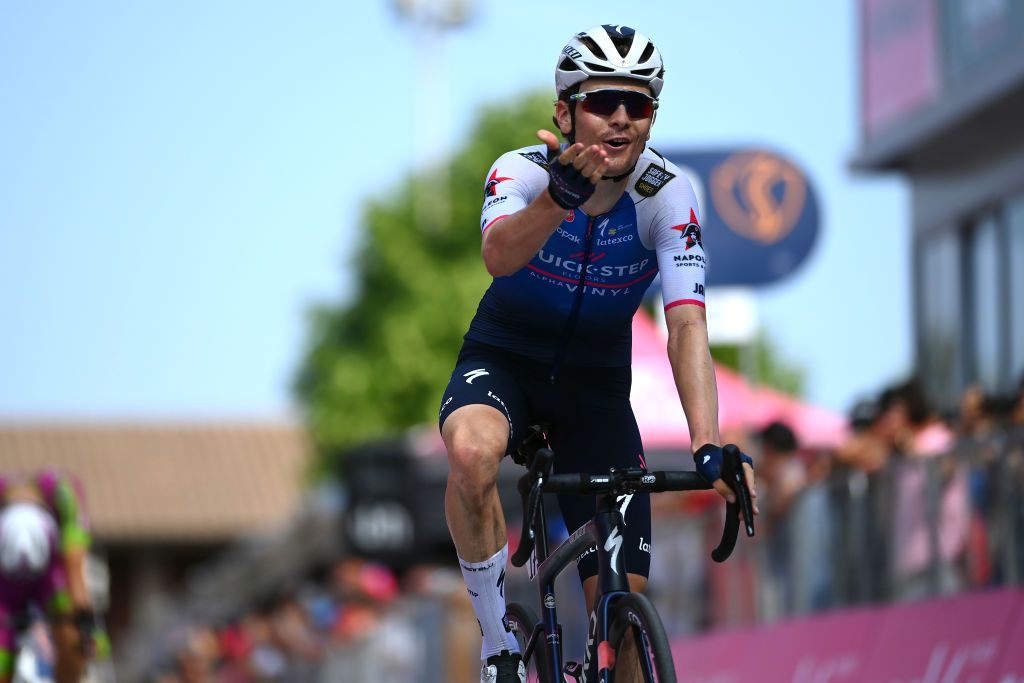 SANTUARIO DI CASTELMONTE ITALY MAY 27 Mauro Schmid of Switzerland and Team QuickStep Alpha Vinyl reacts crossing the finish line on second place during the 105th Giro dItalia 2022 Stage 19 a 178km stage from Marano Lagunare to Santuario di Castelmonte 577m Giro WorldTour on May 27 2022 in Santuario di Castelmonte Italy Photo by Tim de WaeleGetty Images