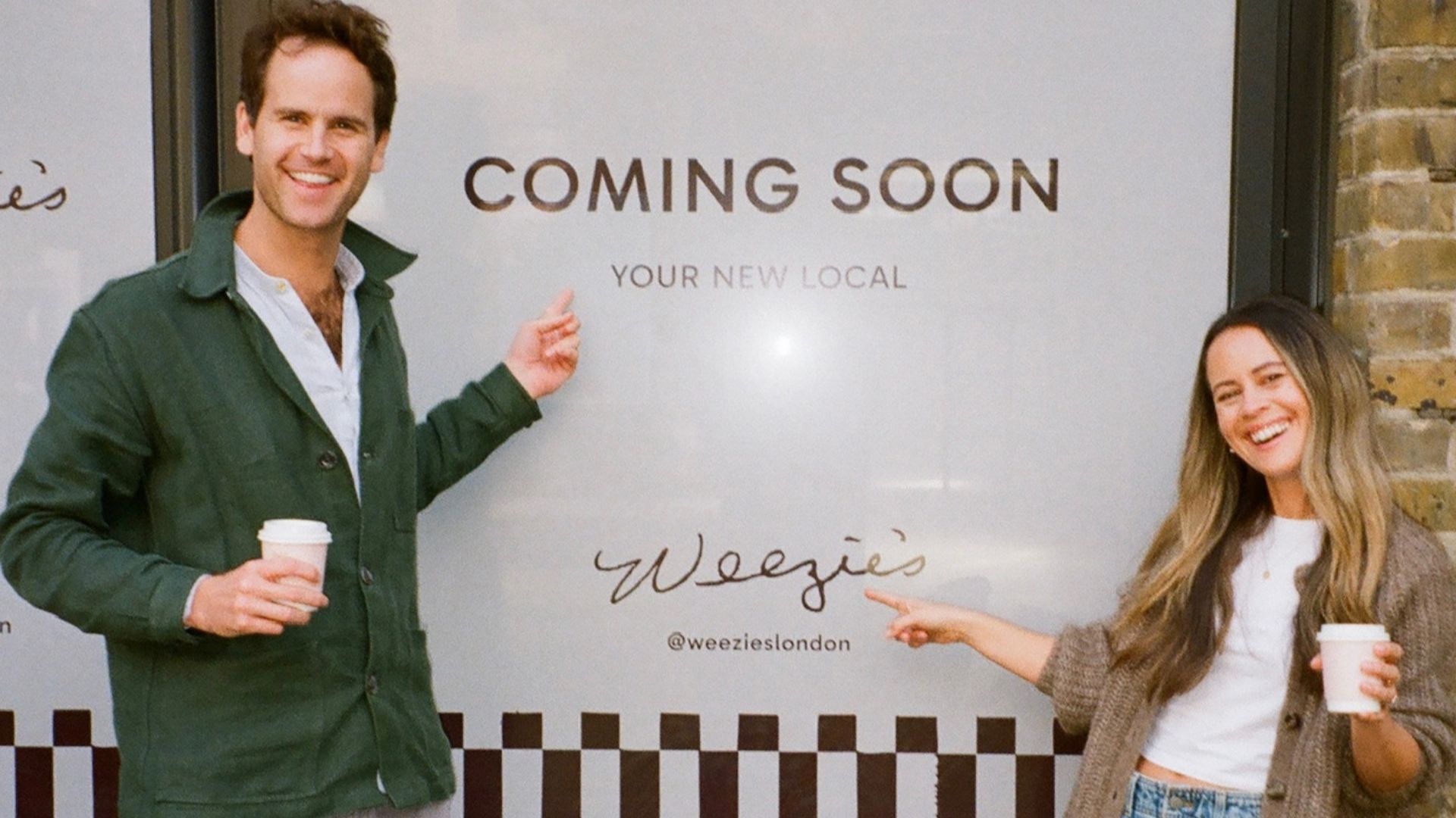 an image of the owners standing outside of the new space