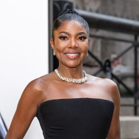 a black woman wearing a black strapless dress