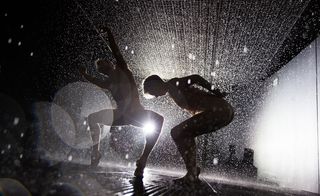 Silhouette of two people dancing a duet