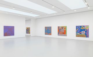 Large paintings on wall of bright gallery