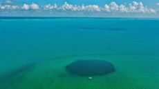An aerial view of the Taam Ja' Blue Hole.