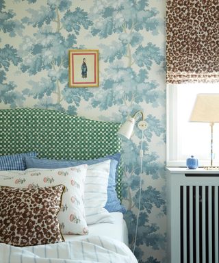 Bedroom with patterned wallpaper and a contrasting patterned headboard