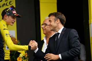 CAUTERETSCAMBASQUE FRANCE JULY 06 LR Jonas Vingegaard of Denmark and Team JumboVisma Yellow Leader Jersey congratulated by Emmanuel Macron of France President of France on the podium ceremony after the stage six of the 110th Tour de France 2023 a 1449km stage from Tarbes to CauteretsCambasque 1355m UCIWT on July 06 2023 in CauteretsCambasque France Photo by David RamosGetty Images