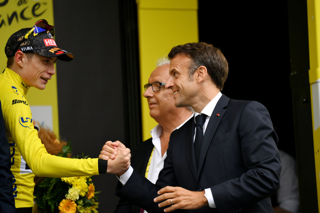 CAUTERETSCAMBASQUE FRANCE JULY 06 LR Jonas Vingegaard of Denmark and Team JumboVisma Yellow Leader Jersey congratulated by Emmanuel Macron of France President of France on the podium ceremony after the stage six of the 110th Tour de France 2023 a 1449km stage from Tarbes to CauteretsCambasque 1355m UCIWT on July 06 2023 in CauteretsCambasque France Photo by David RamosGetty Images