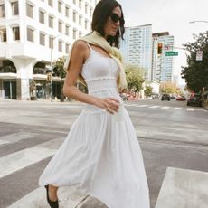 A model wearing a white maxi dress from Abercrombie