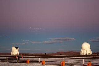 One of the VLT's auxiliary telescope domes open after sunset, with the fading Band of Venus above.