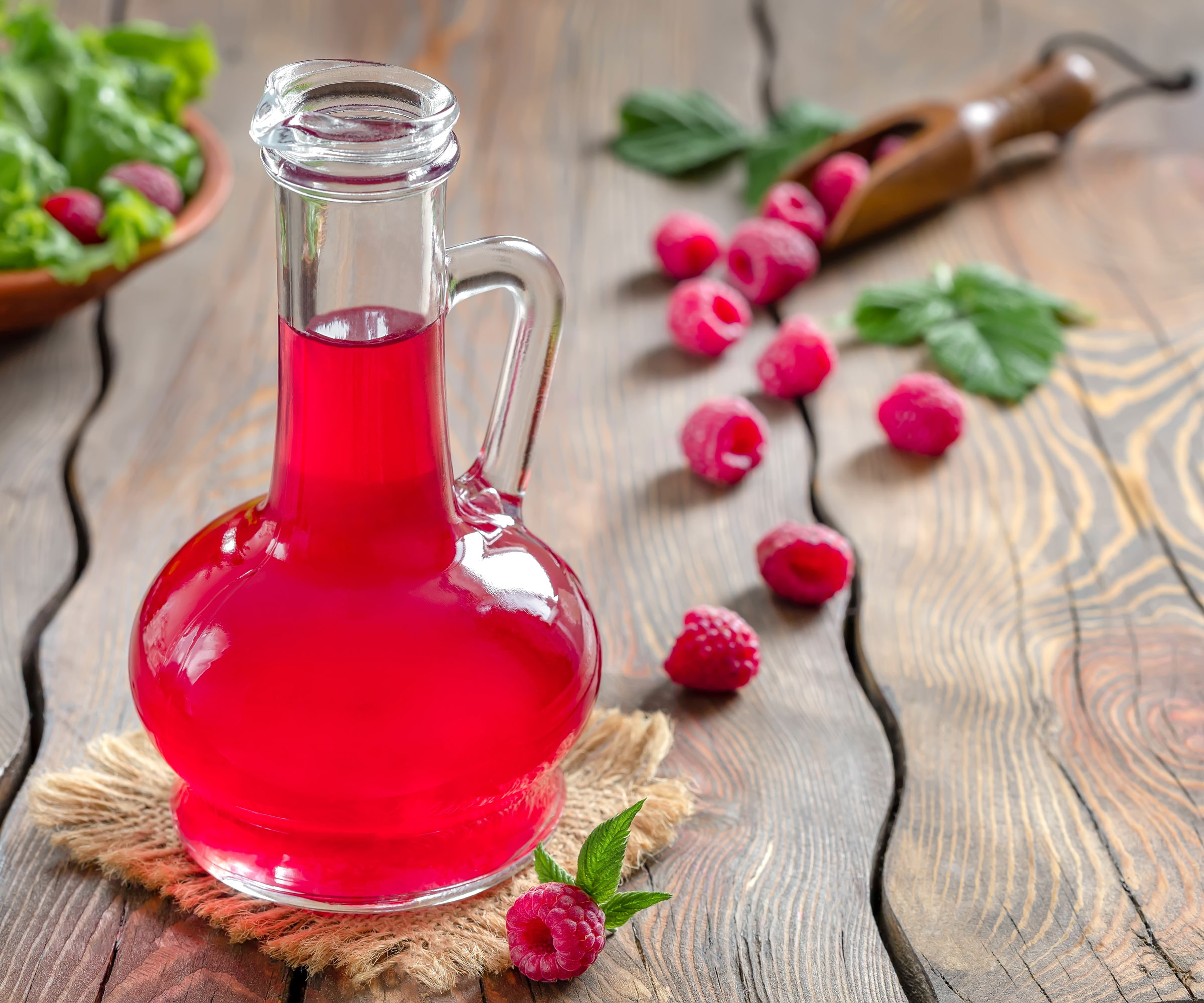 raspberry balsamic vinegar with fruits on wooden table