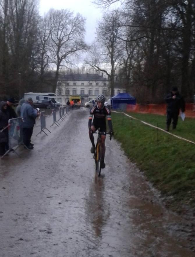 Grant Ellwood trying to stay warm before the race starts in Waremme.