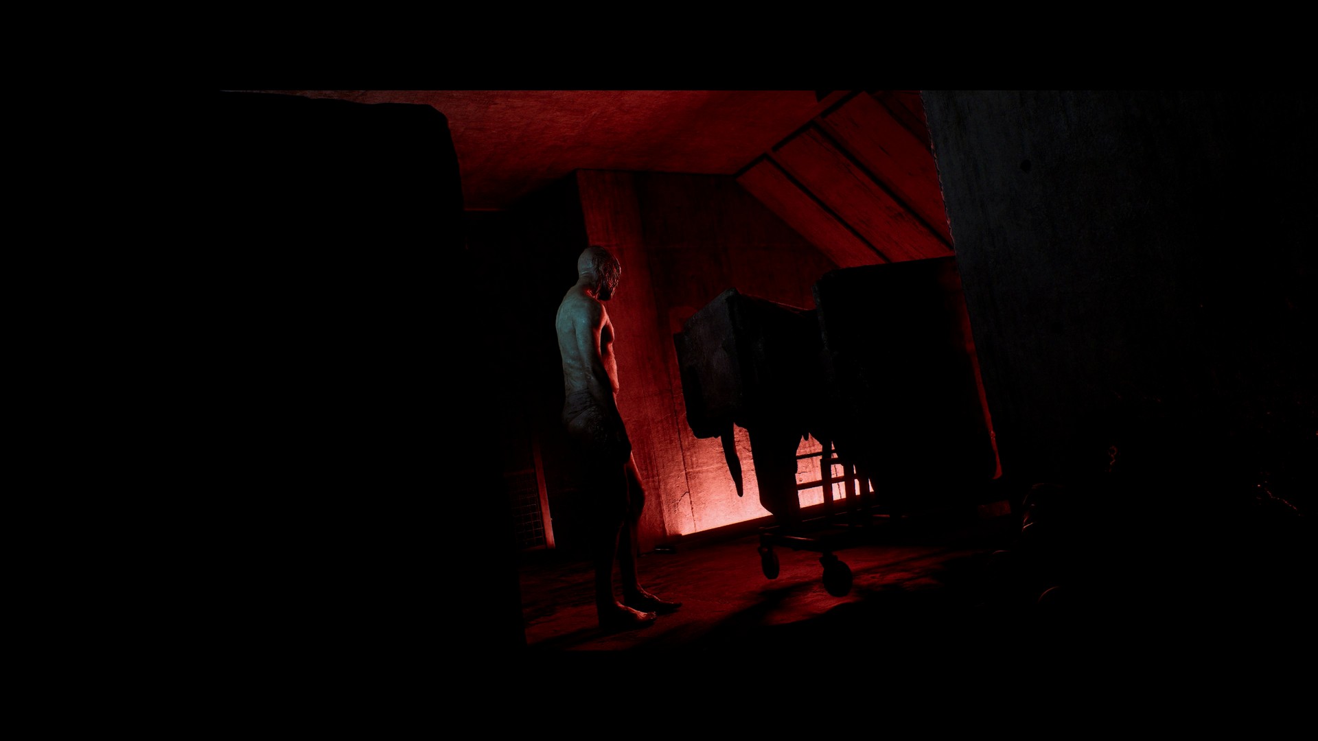 A humanoid with strange facial features is observed at a distance in a strange industrial environment in Silent Hill Townfall