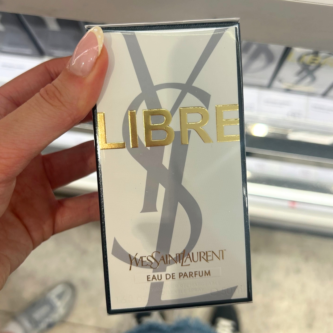 Hand holding box of YSL Libre Eau De Parfum 50ml in World Duty Free