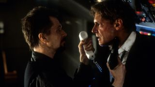 Gary Oldman points a gun at Harrison Ford in Air Force One