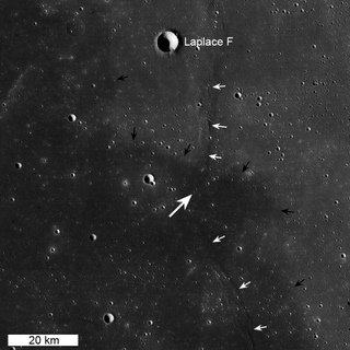 China's Chang'e 3 moon landing site (large white arrow) is seen here in a context view from NASA's Lunar Reconnaissance Orbiter. The small white arrows indicate wrinkle ridge and small black arrows delimit boundary between "red" mare (northeast) and "blue" mare (southwest). This image is 100 km wide and was released Dec. 30, 2013.