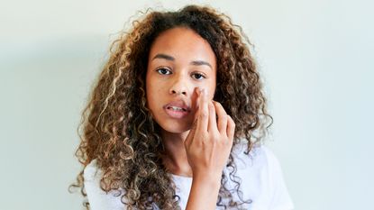 Woman applying retinol oil