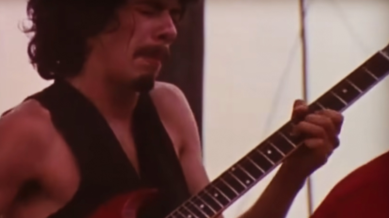 Carlos Santana looking intense while playing guitar
