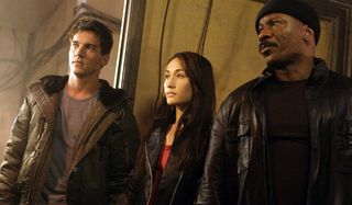 Jonathan Rhys Myers Maggie Q and Ving Rhames lined up to hear a briefing in Mission: Impossible III.