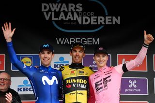 Oier Lazkano (L) with winner Christophe Laporte and third-placed Neilson Powless on the podium of Dwars door Vlaanderen 2023