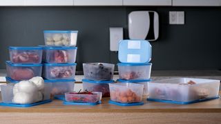 A stack of tupperware containers with food