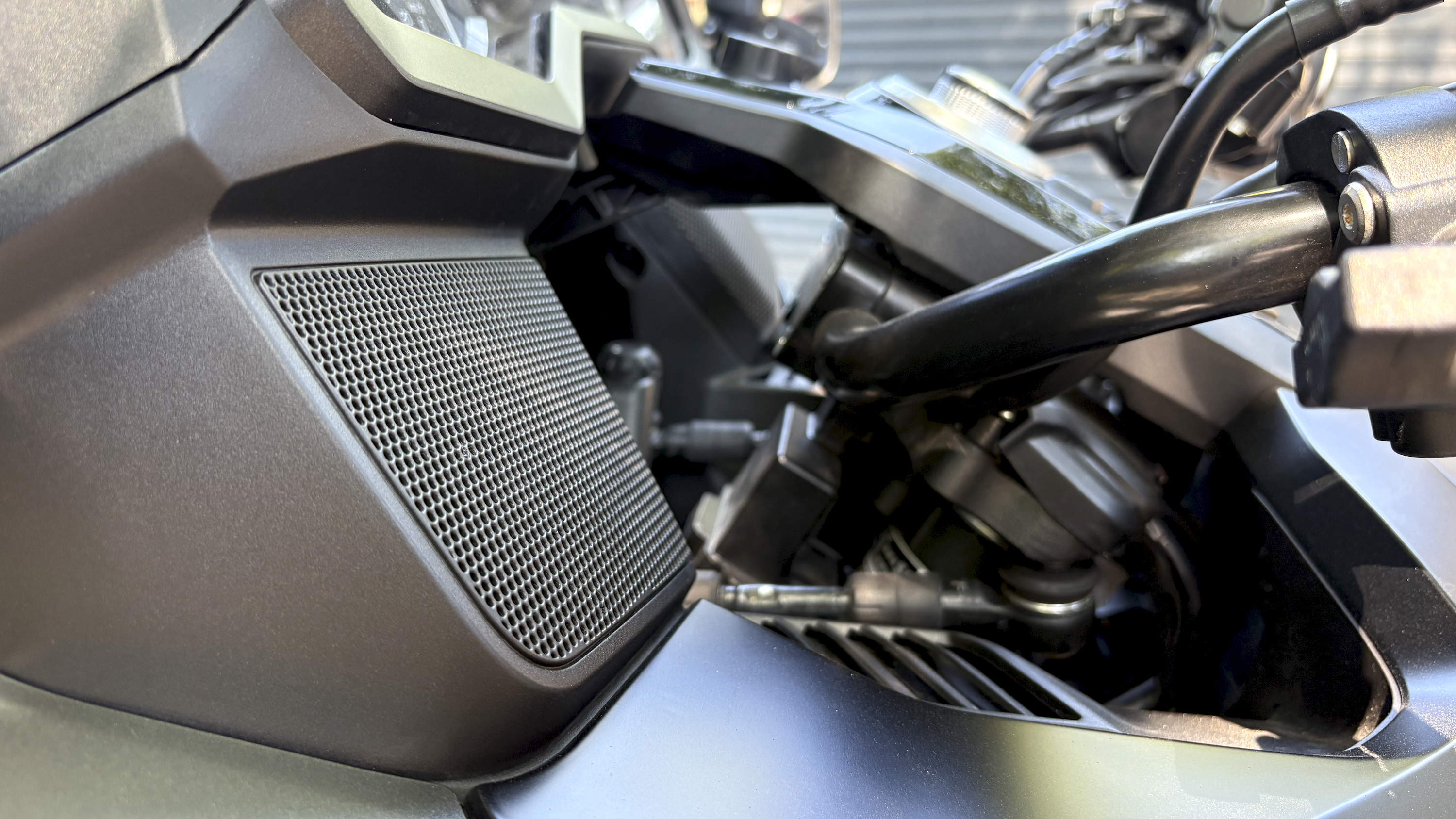A Honda Goldwing touring motorbike, emphasising the sound system onboard, with a driver in a bike helmet