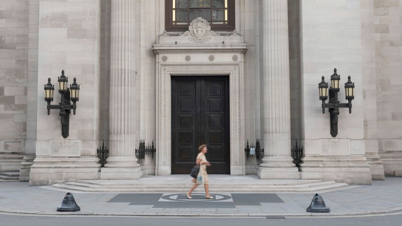 A woman walks past the entrance of Freemasons' Hall in London 